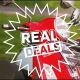real deals logo on a red Vespa gts