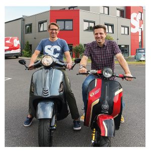 Ulf Schröder and Oliver Kluger on Vespa scooters